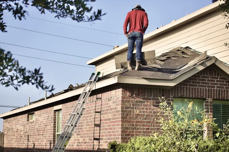 Professional roofer working on a residential roof in Dufur